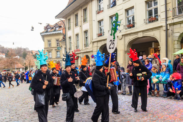 Bern, Switzerland - February 25, 2023: People marching and playing instruments during Bern carnival parade in Bern, Switzerland