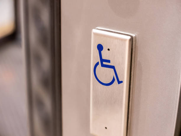 istock A metal button with a blue wheelchair symbol on it, object closeup, nobody. Accessibility for the disabled, building architectural design friendly for people with disabilities simple abstract concept 2003916667