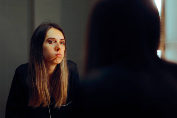 istock Stressed Woman Looking in the Mirror Feeling Anxious 2003994924
