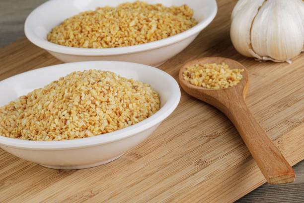 A close up of the spice Minced Garlic isolated on a wooden background with copy space