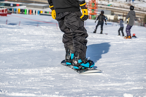 Close up snowboarder on top of the hill ready to go