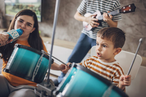 istock A Girl Singing Into A Microphone While Other Children Playing Instruments 2004090344