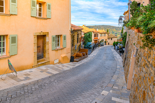 A winding hill road in the colorful hilltop town of Ramatuelle, France, in the Provence Cote d'Azur region of Southern France. Ramatuelle is a commune in the Var department of the Provence-Alpes-Côte d'Azur region in Southeastern France.