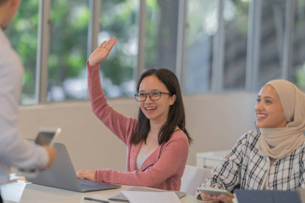 istock Asian female student rise hand 2004143885