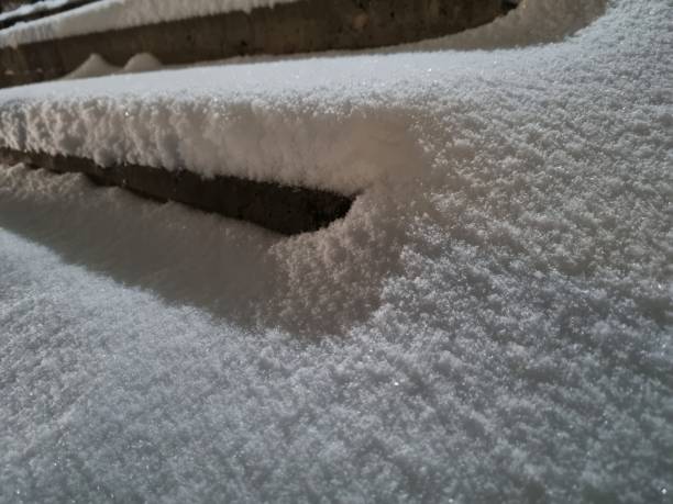 istock Snow covered street steps close up 2004164133