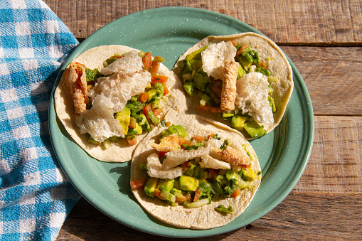 Traditional mexican tacos Placeros made with pork chicharron and fresh guacamole.