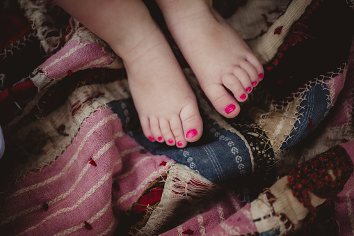 Little girl's toes with pink painted toenails