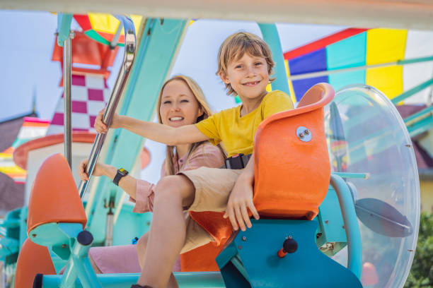 istock happy smiling son and his mother spending fun time together at amusement park 2004209423