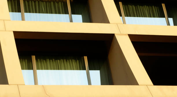istock Abstract image of looking up at modern glass and concrete building. Architectural exterior detail of office building. 2004241119
