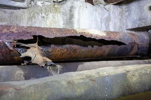 There is a horizontal cracked rain drain in the basement or crawl space