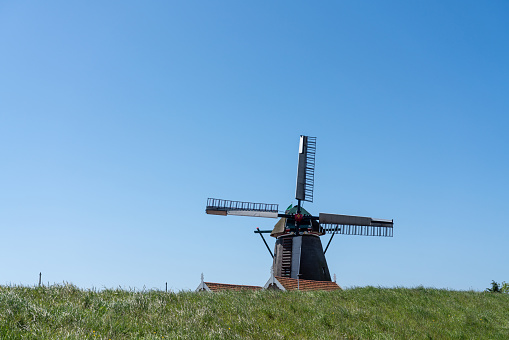 Early in the morning there is a beautiful windmill whit Blue sky