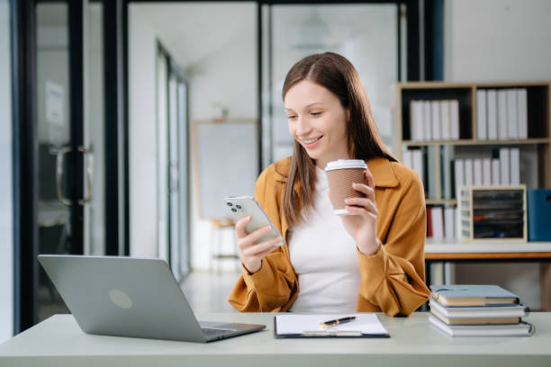 istock Confident woman with a smile standing holding notepad and tablet at the office. 2004271372