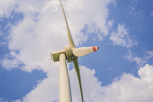 Wind power plant. green meadow with Wind turbines generating electricity.