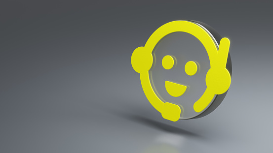 Chatbot, call centre, customer support concept - emoticon with a microphone and headphones 3d symbol. Yellow 3d icon with transparent glass element on grey background with copy space on the left.