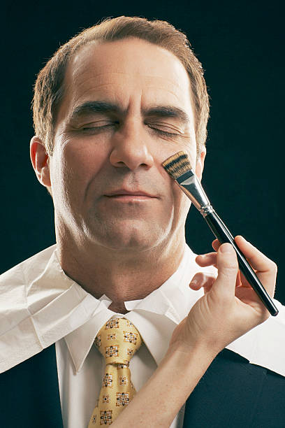 mature man having make-up done - ogen dicht closeup vrouw 50 jaar stockfoto's en -beelden