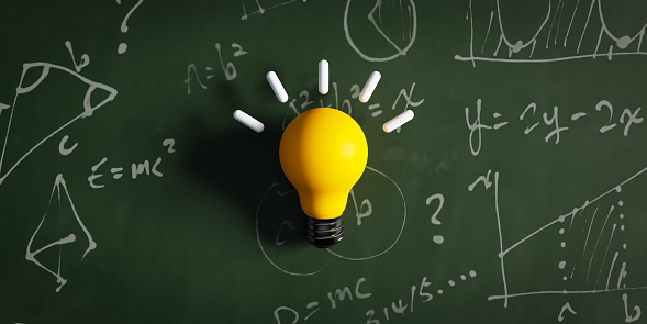 Concept with a yellow idea light bulb against the backdrop of handwriting on a blackboard. 3d rendering