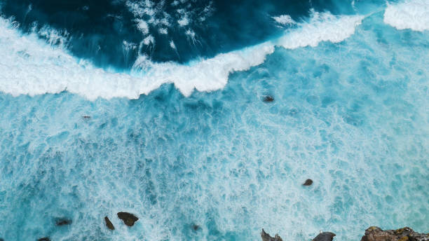 istock Turquoise ocean sea water white wave pattern splashing deep blue sea. Seascape dark ocean background wave splash on rock. Tropical sea beach in summer seaside outdoor. Water Surface blue wave pattern 2004295447