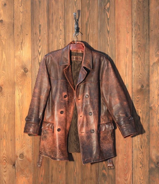 istock old brown leather jacket on a hanger on a wooden wall 2004299569