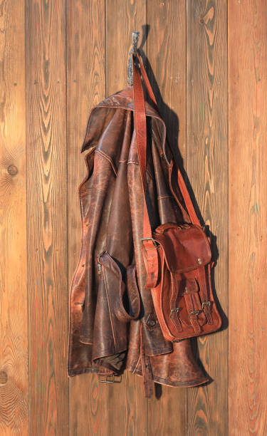 istock old brown leather jacket on a hanger on a wooden wall 2004300633