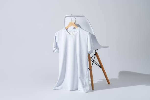 istock Blank white T-shirt hanging on a chair on white background 2004311128