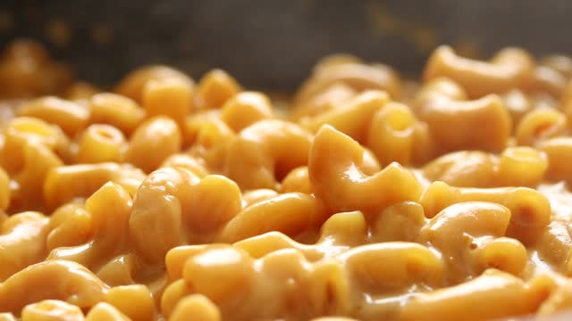 Boiled Macaroni and Cheese Sauce Cooking in a Pan.