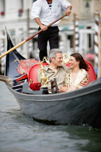 Venice, Italy - 04 08 2017: Tourists are sightseeing Venice canals in gondola boat, Italy. Venice is one of the most important tourist destinations in the world for its celebrated art and architecture.