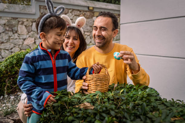istock Young Family and Baby Boy on Easter egg hunt game at back yard 2004364991
