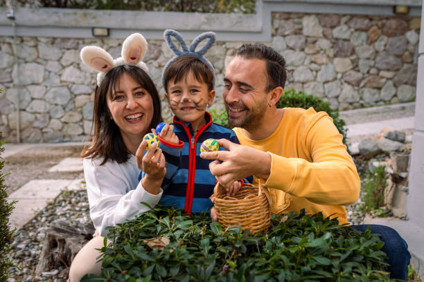 istock Young Family and Baby Boy on Easter egg hunt game at back yard 2004365508