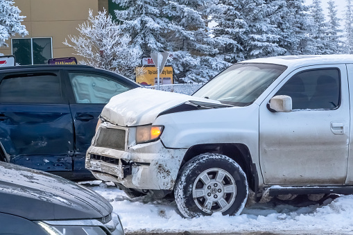 Calgary, Alberta, Canada. Feb 8, 2024. The frontal perspective of a Honda Ridgeline post-collision, exhibiting extensive damage to the front hood amid winter conditions.