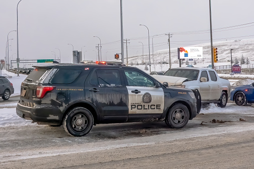 Calgary, Alberta, Canada. Feb 8, 2024. A Calgary Police vehicle providing assistance to a driver involved in a crash.