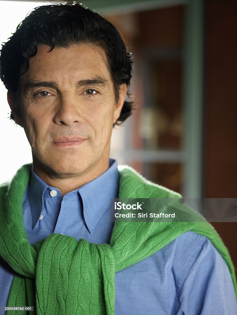 Mature man wearing shirt with sweater around shoulders, portrait  Shoulder Stock Photo