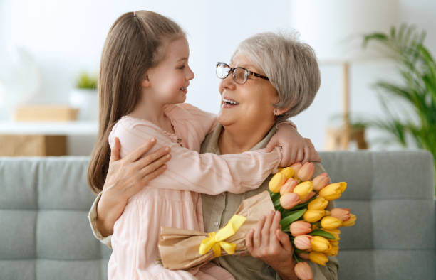 istock Grandma and girl smiling and hugging 2004397565