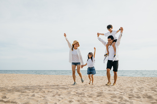 Shot of an adorable little girl having a fun day at the beach with her parents and grandparents