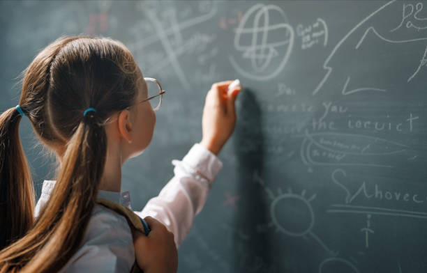 istock Kid in class on background of blackboard 2004417257