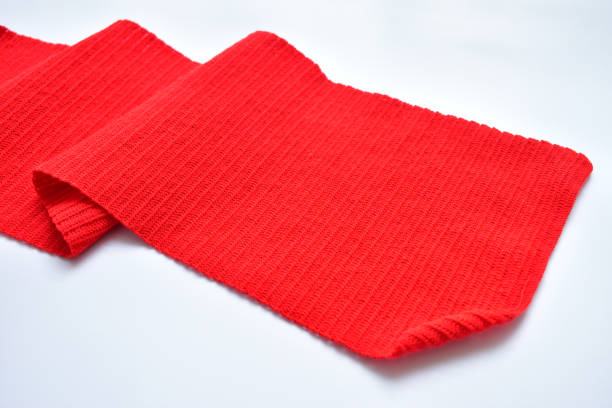 istock wavy of red wool knitted yarn texture, woolen fabric on white background 2004418292