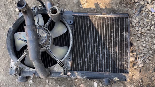 Used car radiator with fan and rubber hose