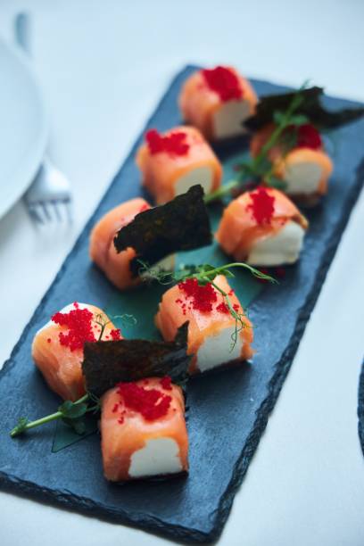 istock Rolls of red fish and cheese on the festive table. 2004454135