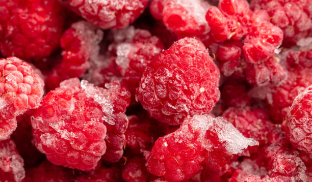 istock Frozen raspberries and blackberries close-up macro photography 2004457354