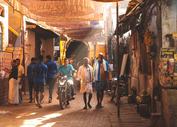 mattina a gokarna, persone che camminano lungo una strada. india - indian ethnicity traditional culture architecture karnataka foto e immagini stock