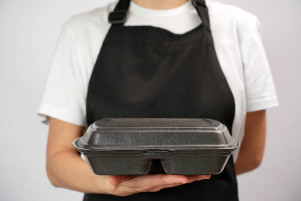istock Chef holding lunch box with food in the hand, white background 2004466391