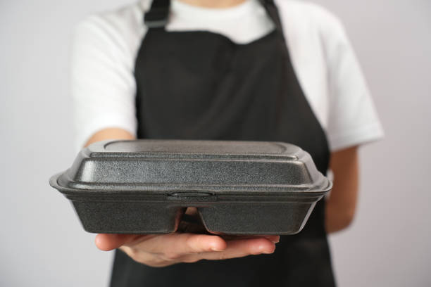 istock Chef holding lunch box with food in the hand, white background 2004466403