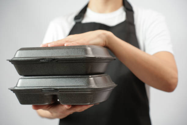 istock Chef holding lunch box with food in the hand, white background 2004466406