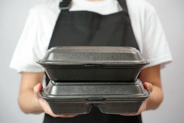istock Chef holding lunch box with food in the hand, white background 2004466412
