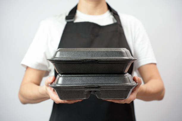 istock Chef holding lunch box with food in the hand, white background 2004466415