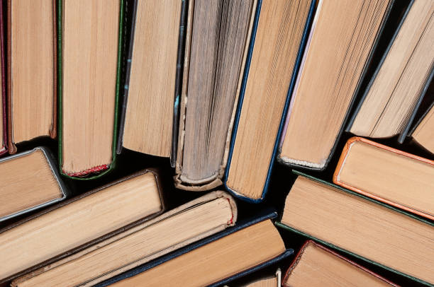 istock Many different hardcover old books on dark background, top view 2004480583