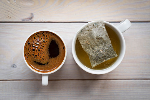 Two cups with coffee and green tea