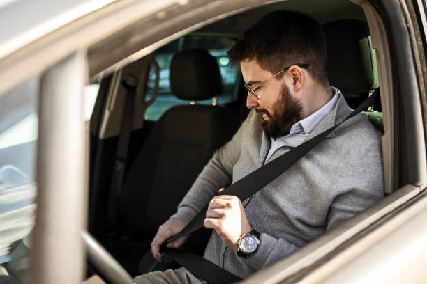 istock Businessman driving his car locking seat belt 2004490132