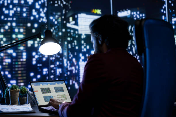 istock Powerful businessman enjoying nighttime office view as he works after hours 2004490156