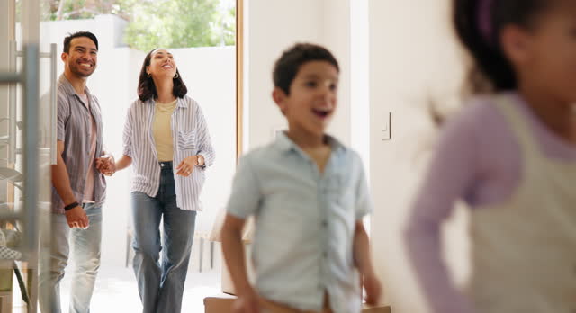 Parents, new home and children running, walking and excited for moving in, mortgage and real estate at entrance. Interracial family, mom and dad with kids in front door for dream house or property