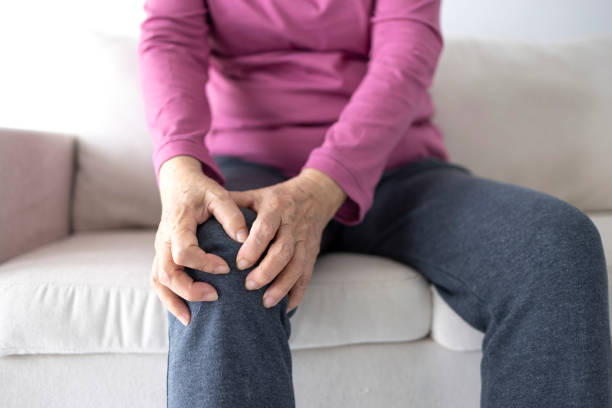 istock senior woman suffering from knee ache 2004506212